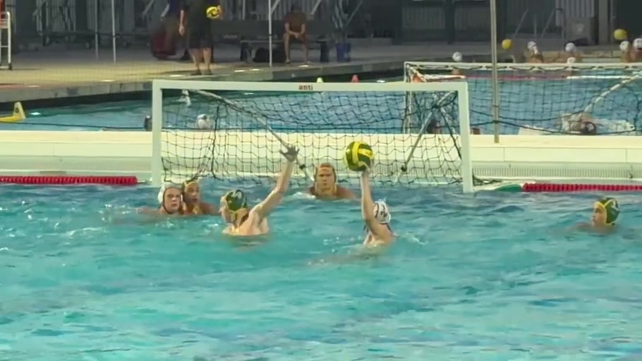 A Whitney player raises the ball in front of a Kingsburg defender and the goal.