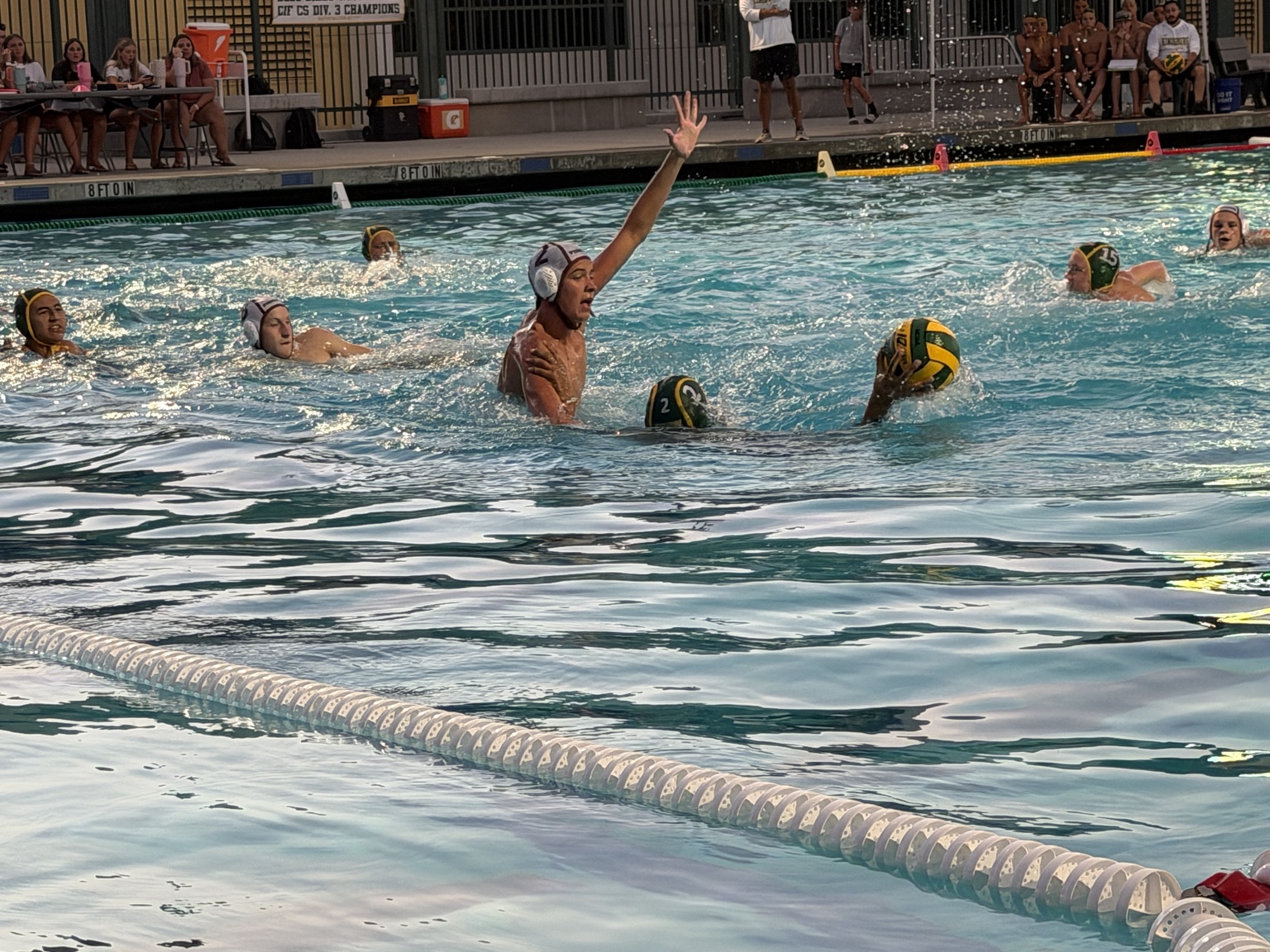 Whitney No. 2 raises an arm in front of the Kingsburg ball carrier.